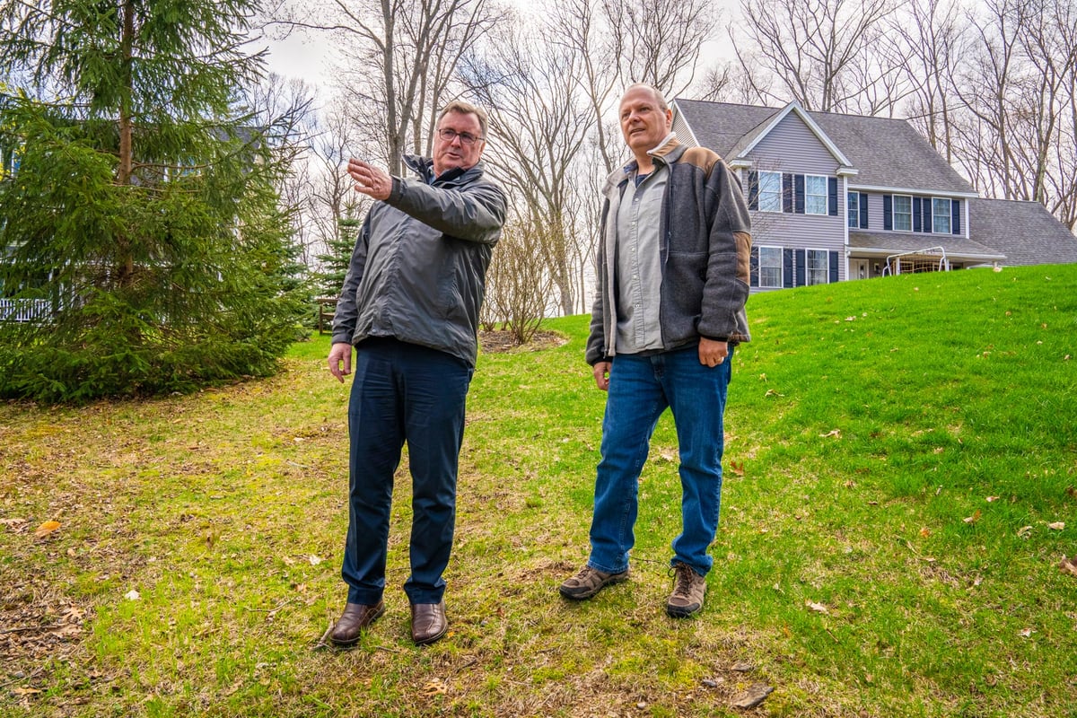 customer and arborist inspect trees