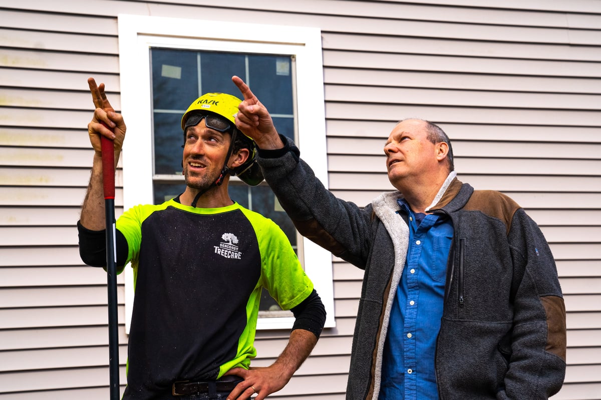 tree care leader inspects property with customer