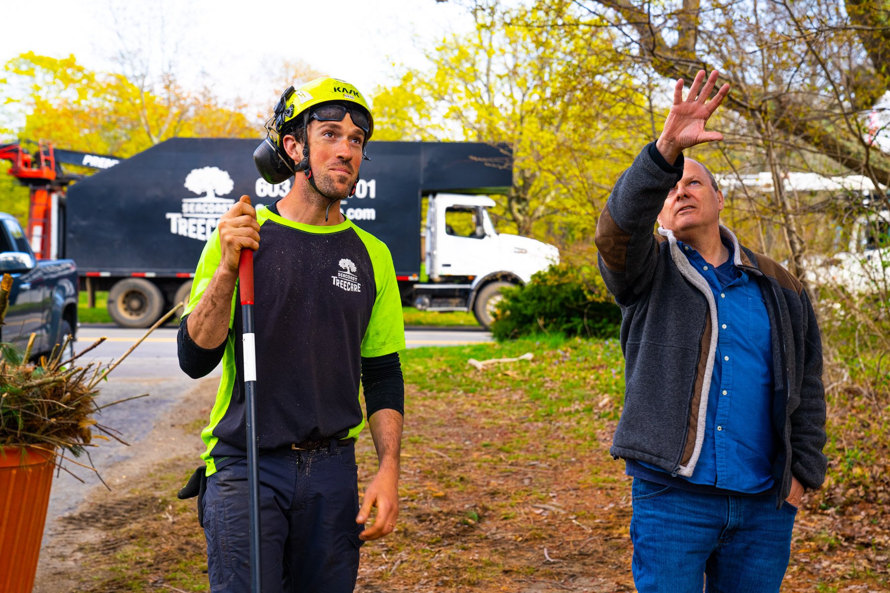 tree crew leader reviewing tree work with a homeowner